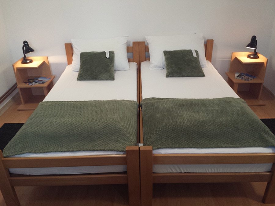 Comfortable sleeping area with double bed in a private studio apartment in Subotica