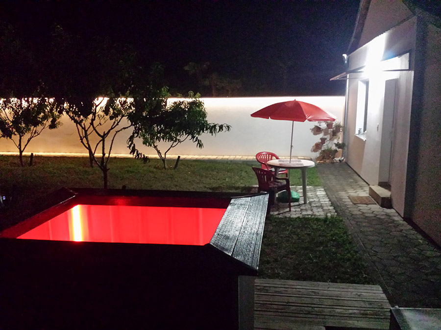 Wood-fired garden hot tub at night in Subotica, Serbia